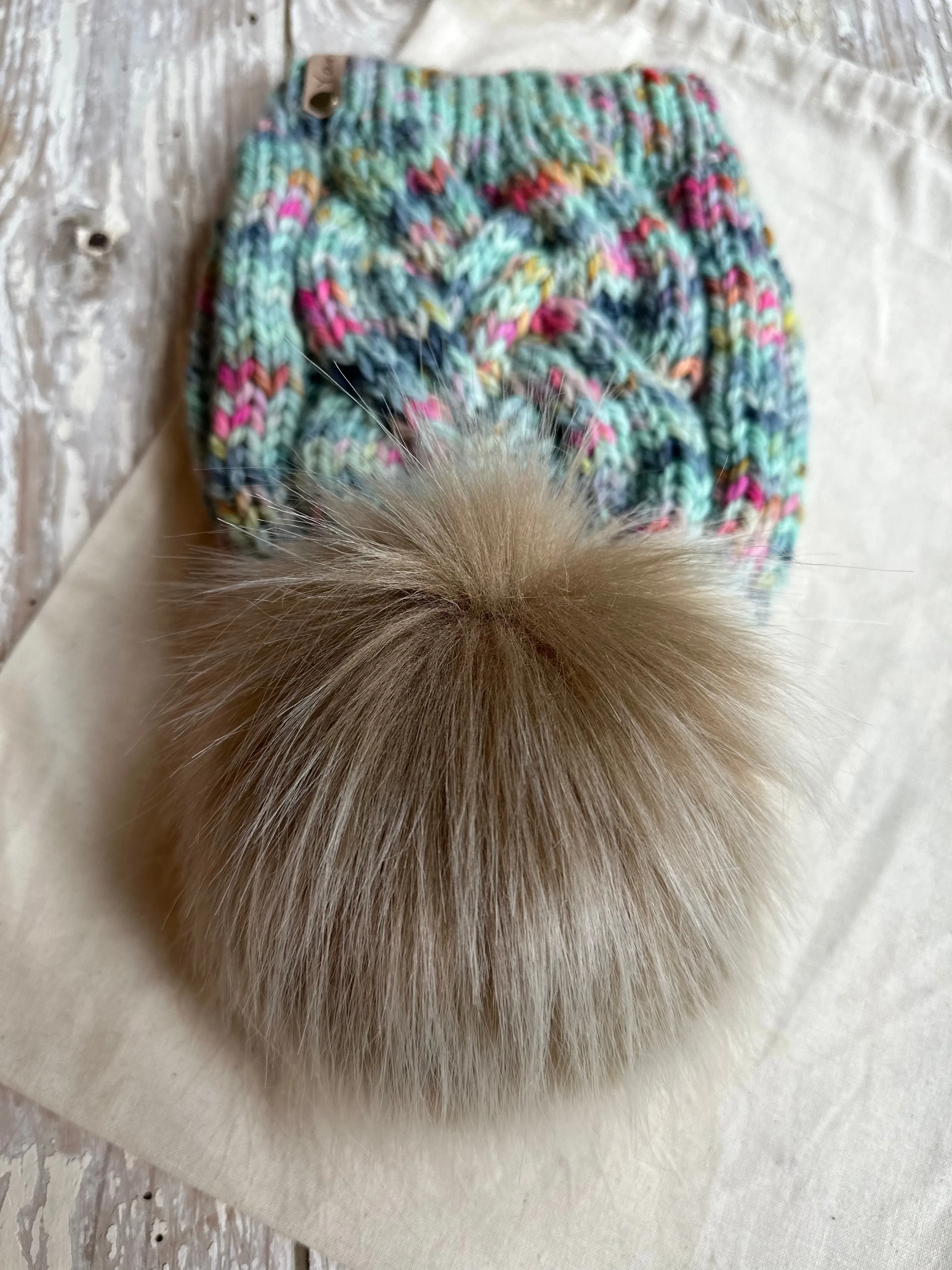 Merino wool cable knit beanie with faux fur Pom